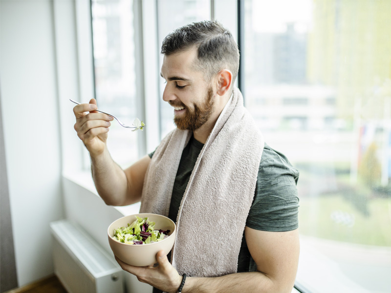 Athlete eating a salad after workout